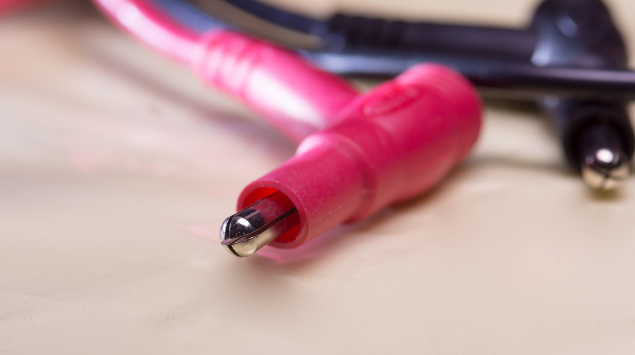 technician using digital multimeter to test circuits